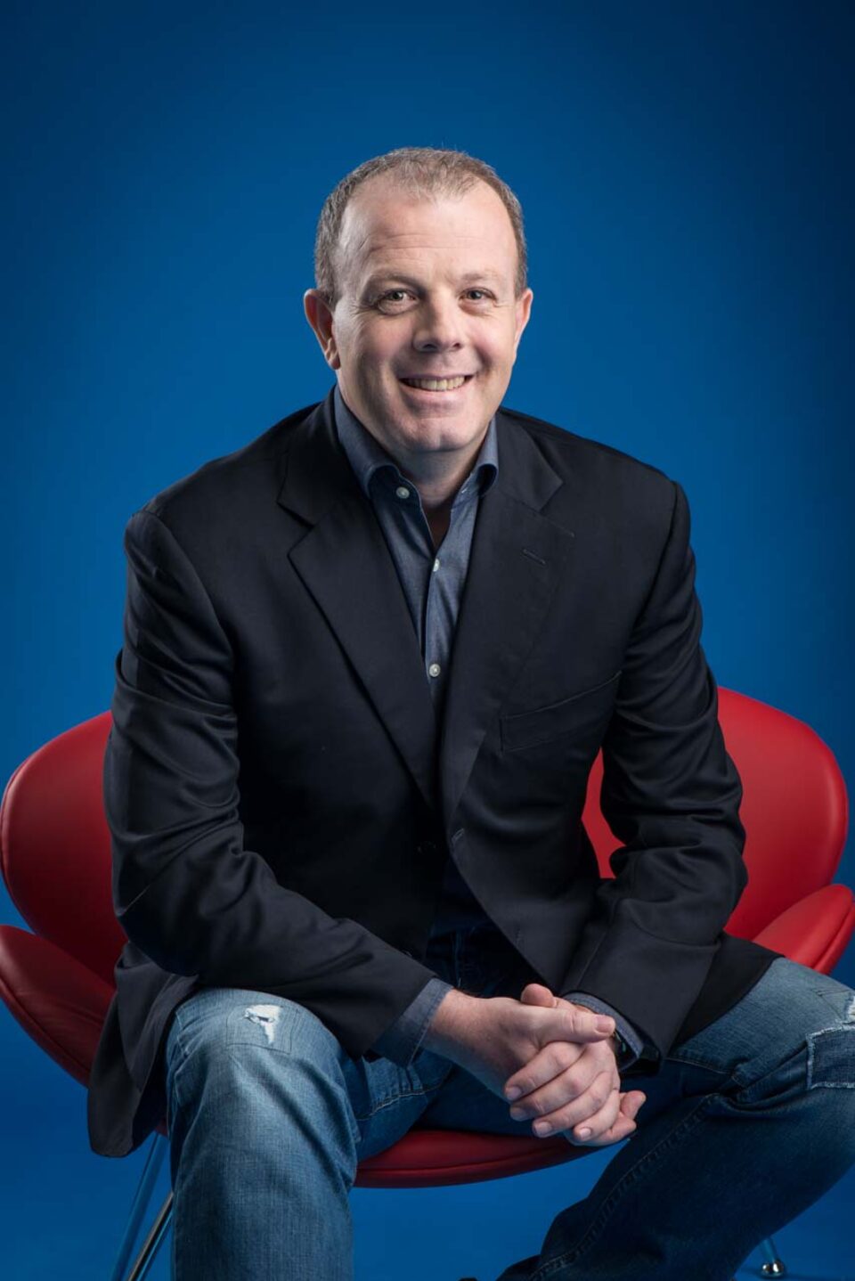 Second corporate portrait of Brett Conway seated in a red chair — singapore corporate portrait photography, corporate portrait photographer singapore