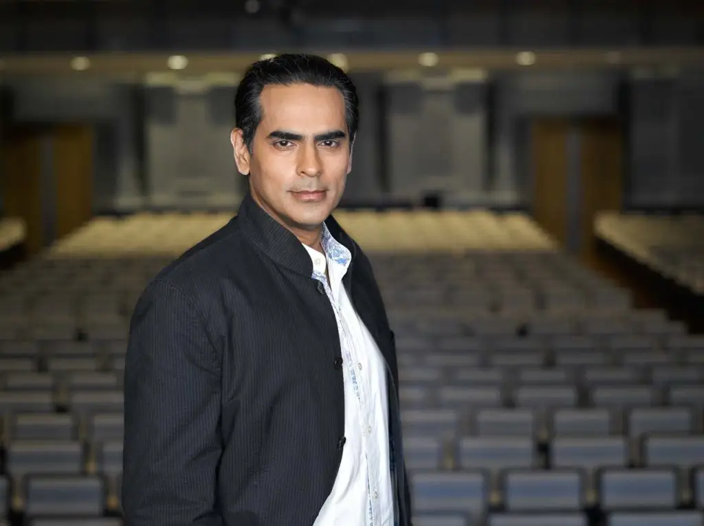 Gaurav Kripalani standing in the Victoria Concert Hall auditorium — environmental portrait photographer singapore, on location corporate portrait singapore