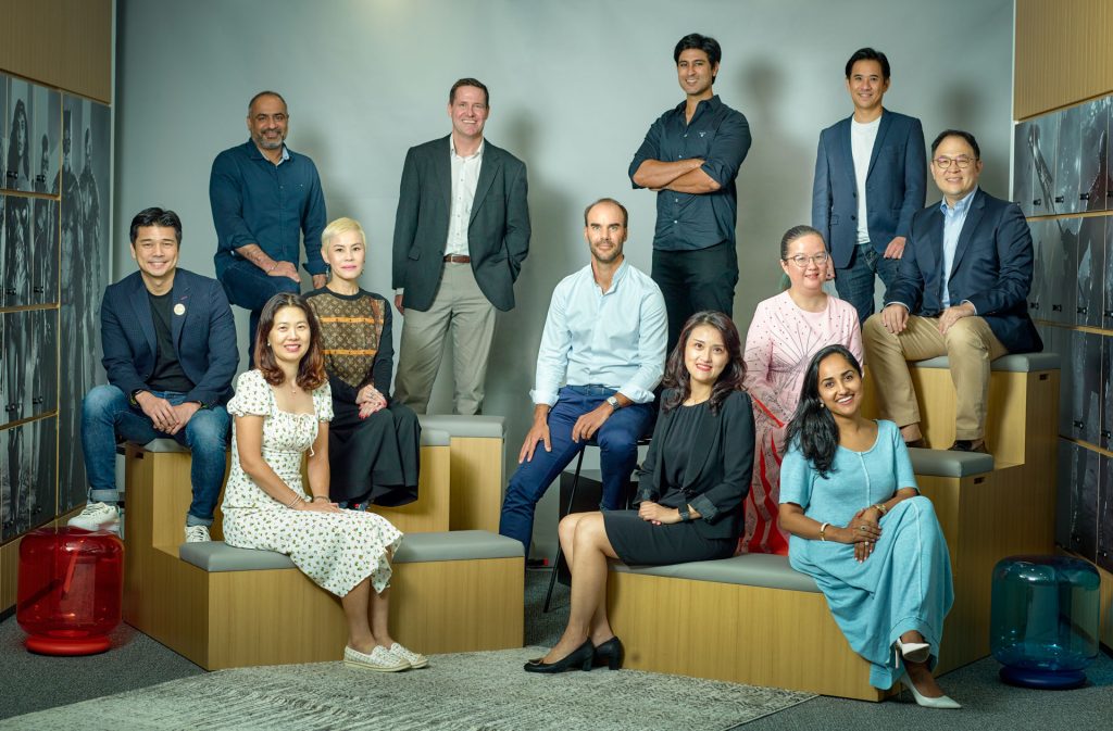 Corporate team group portrait arranged on tiered office seating in Singapore