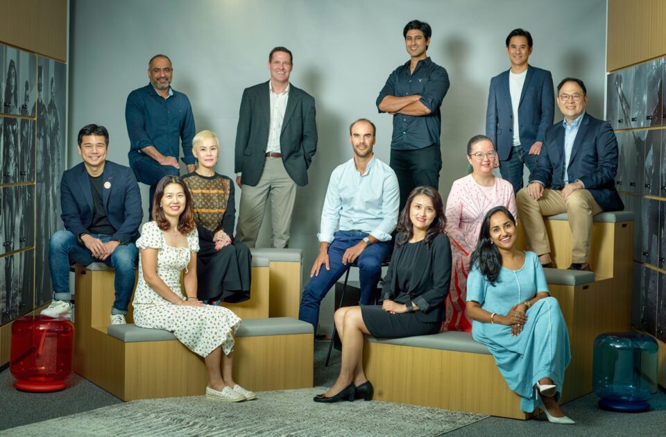 Corporate team group portrait arranged on tiered office seating in Singapore — corporate group portrait photographer singapore, team portrait photography singapore