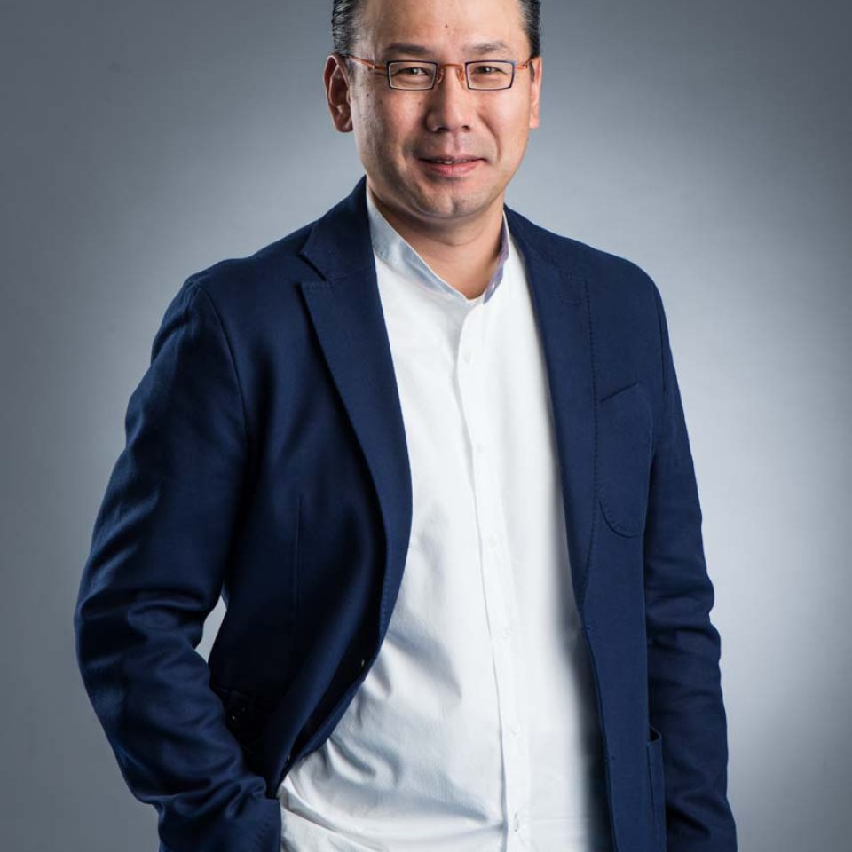 Professional executive headshot of a finance executive in a navy blazer over a white t-shirt, arms folded — singapore C-suite portrait photography