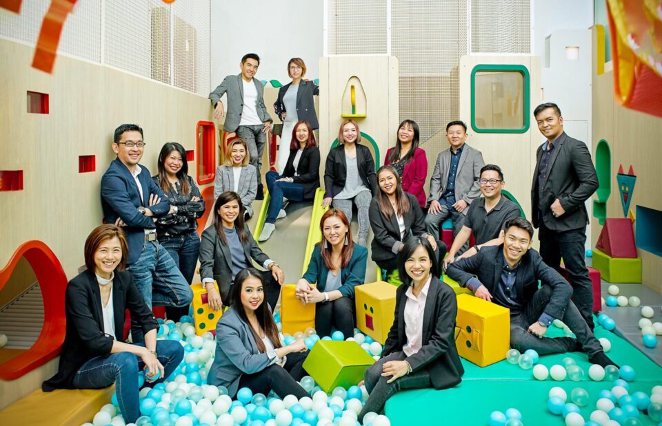 Playpoint ASEAN team group portrait photographed in a colourful indoor playground — corporate group portrait photographer singapore, team portrait photography singapore