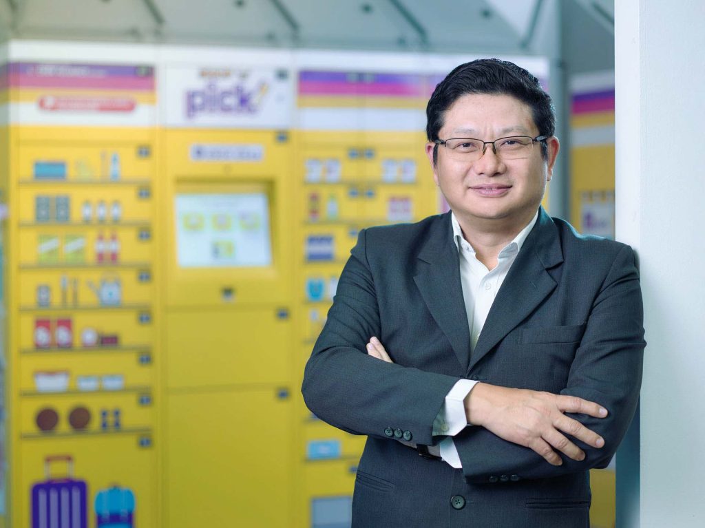 Soon Tee New, Chief Executive Officer of Pick Network, photographed beside a yellow parcel locker