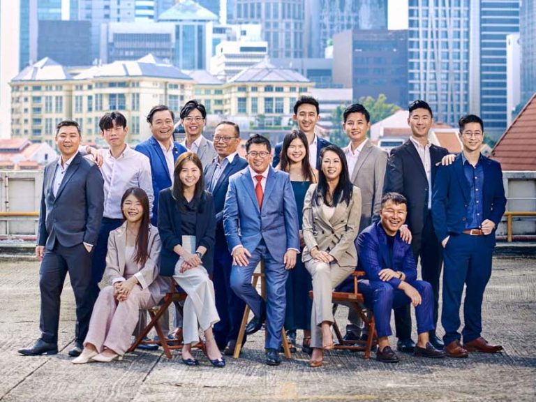 Large corporate team photographed outdoors in Singapore for a stylish group portrait