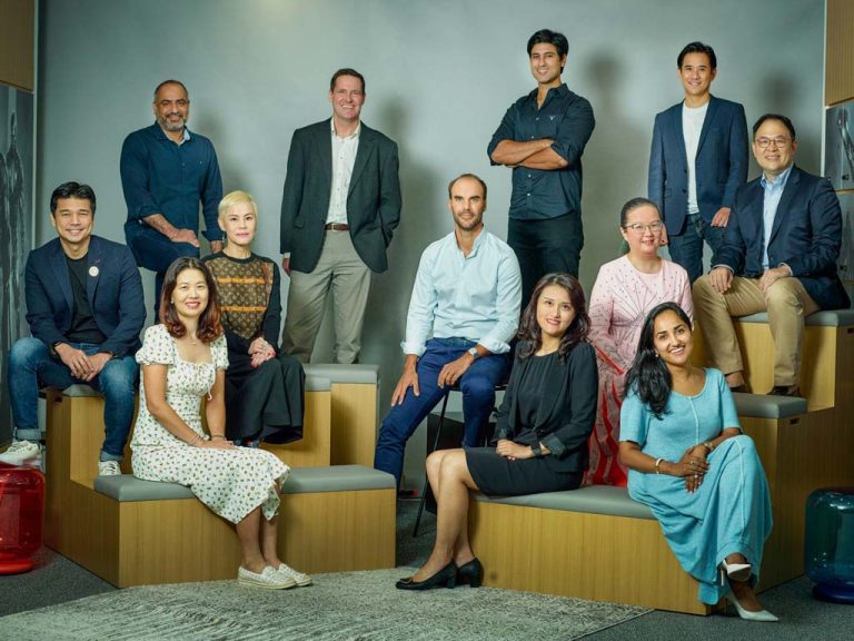 Warner Bros. Discovery leadership team in a relaxed group portrait in their Singapore office
