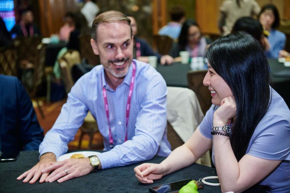 Two delegates in discussion at a table at the IAPP Asia Privacy Forum 2024 — singapore corporate events photographer, professional corporate events photography singapore