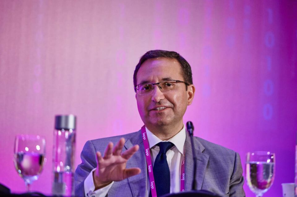 Speaker gesturing under magenta stage lighting at the IAPP Asia Privacy Forum 2024 — singapore corporate events photographer, professional corporate events photography singapore