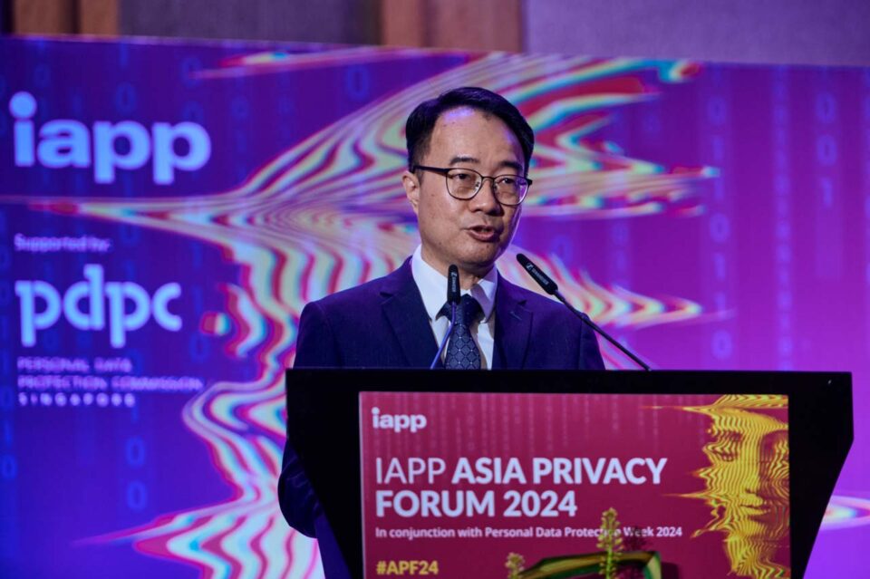 Speaker at the lectern in front of the IAPP and PDPC Asia Privacy Forum 2024 screen — singapore corporate events photographer, professional corporate events photography singapore