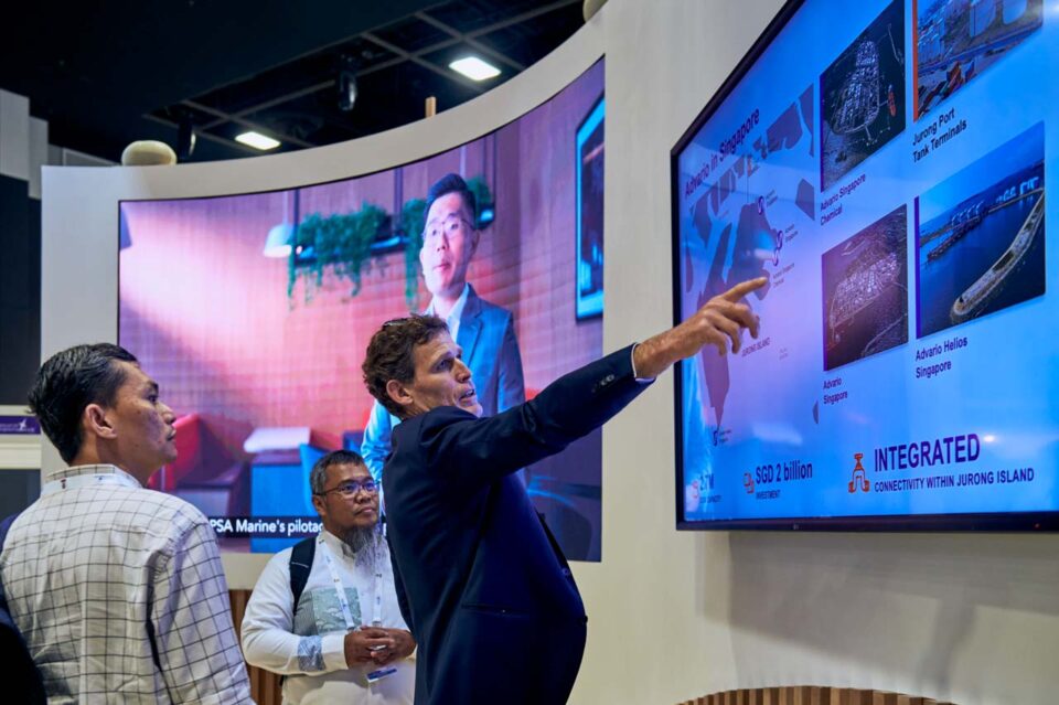 Presenter pointing to content on the stand screen at Singapore Maritime Week — singapore corporate events photographer, professional corporate events photography singapore