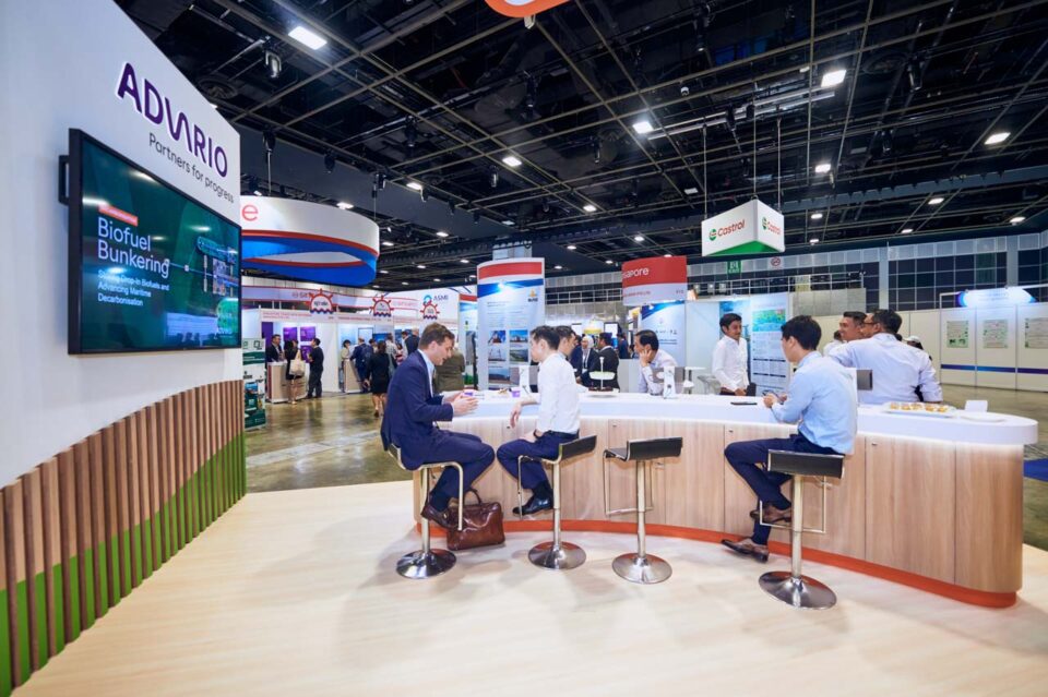 Wide view of the Advario stand with seating and screens at Singapore Maritime Week — singapore corporate events photographer, professional corporate events photography singapore