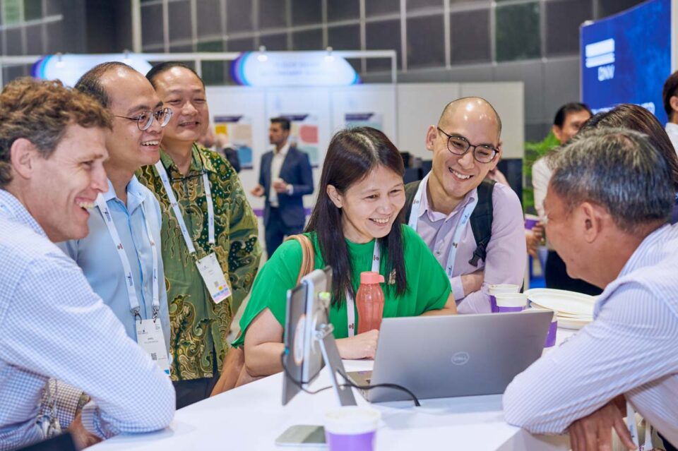 International delegates in conversation at the Advario stand, Singapore Maritime Week — singapore corporate events photographer, professional corporate events photography singapore