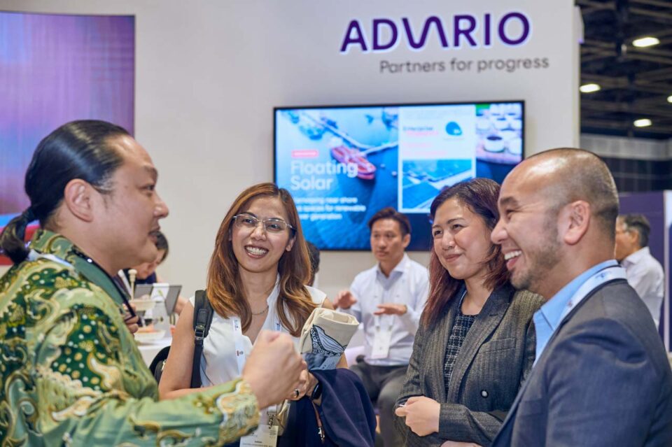Delegates in conversation in front of the Partners for Progress screen at Singapore Maritime Week — singapore corporate events photographer