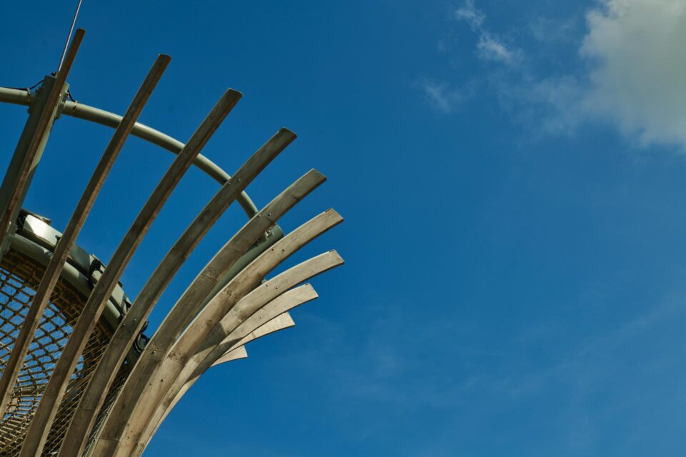 Detail of the curved play structure at the Kompan playground against a clear blue sky — singapore corporate events photographer, corporate event photography singapore