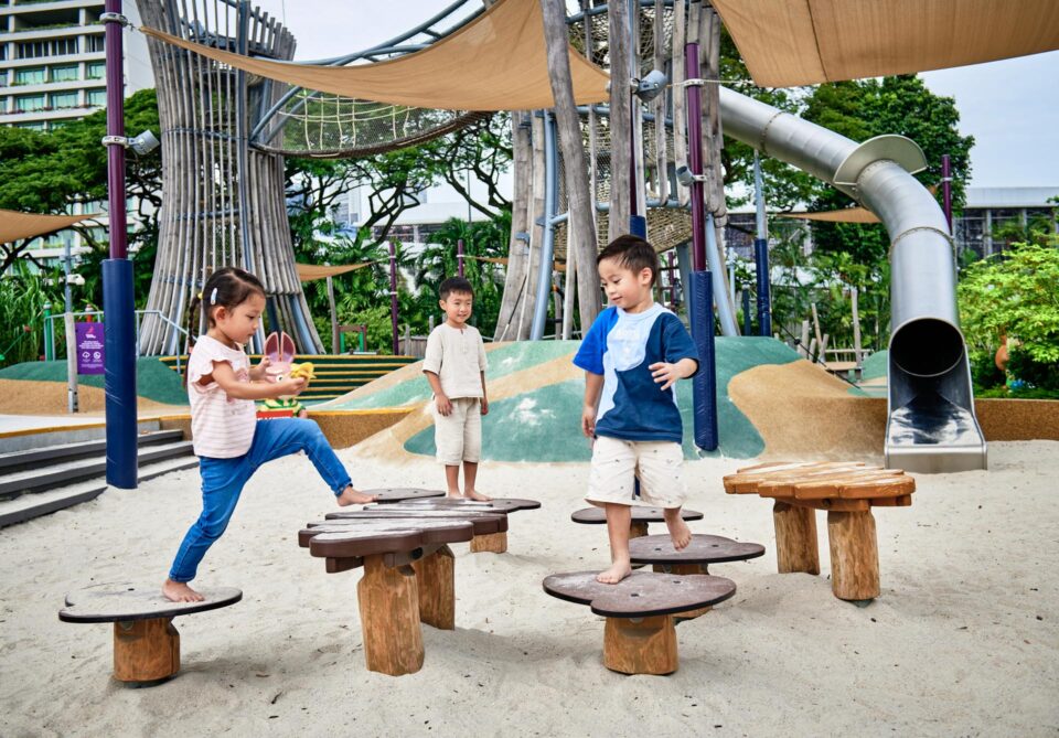 Children playing on the wooden balance equipment at the Kompan playground at Gardens by the Bay — singapore commercial photographer, corporate photographer singapore