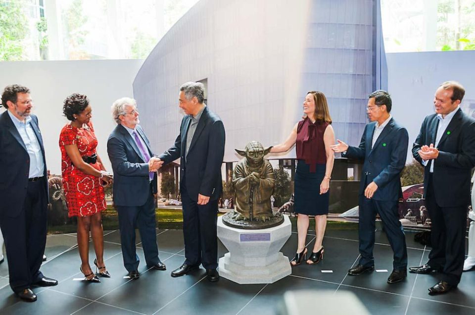 Guests gathered around a scale model at the 2014 Lucasfilm Sandcrawler official opening — singapore corporate events photographer, professional corporate events photography singapore