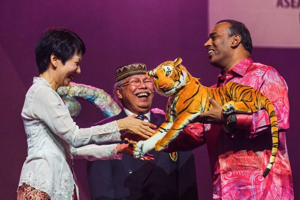 Guests holding a ceremonial lion head at the closing ceremony of the 2015 ASEAN Para Games — singapore corporate events photographer, conference photography singapore