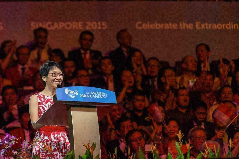 Speaker at the lectern before a Singapore 2015 Celebrate the Extraordinary screen at the ASEAN Para Games — singapore corporate events photographer