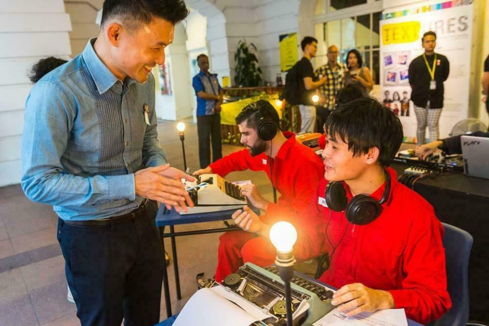 Guest examining a lighting exhibit at Textures 2018 at The Arts House — singapore commercial photographer, corporate photographer singapore