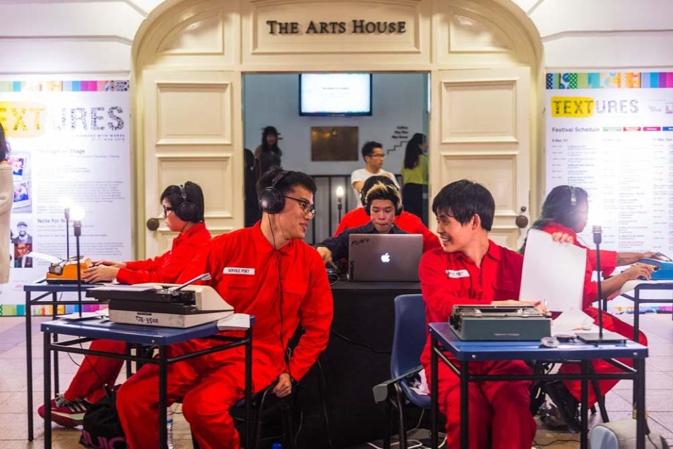 Crew in orange jumpsuits working at a technical station during Textures 2018 at The Arts House — singapore commercial photographer, corporate photographer singapore