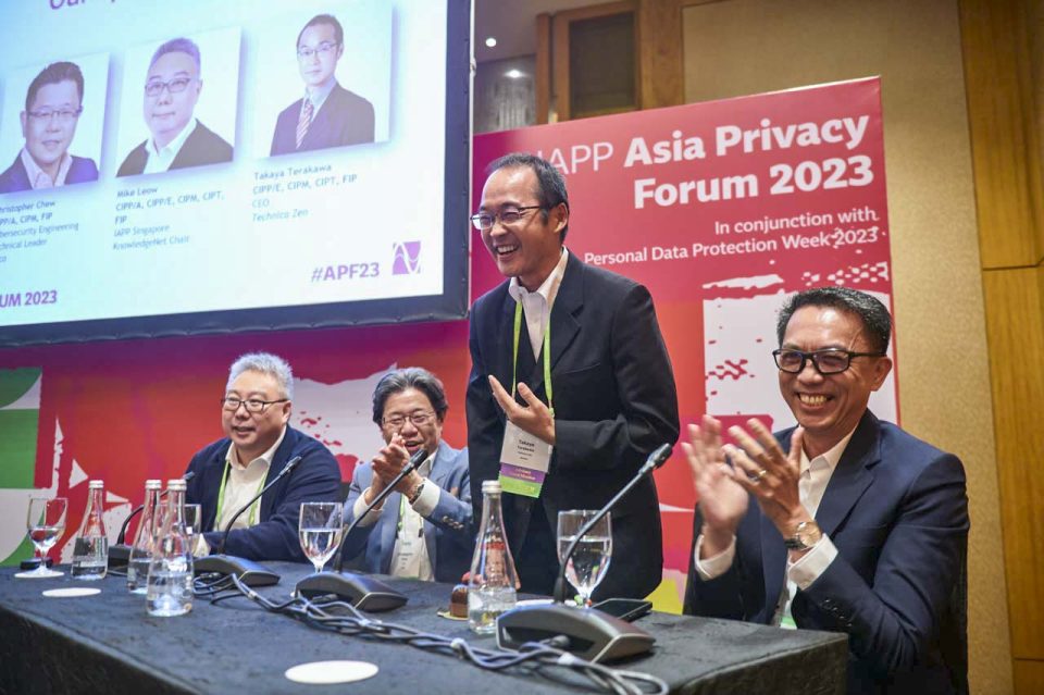 Panel of speakers seated at the table under the IAPP Asia Privacy Forum 2023 backdrop — singapore corporate events photographer, professional corporate events photography singapore