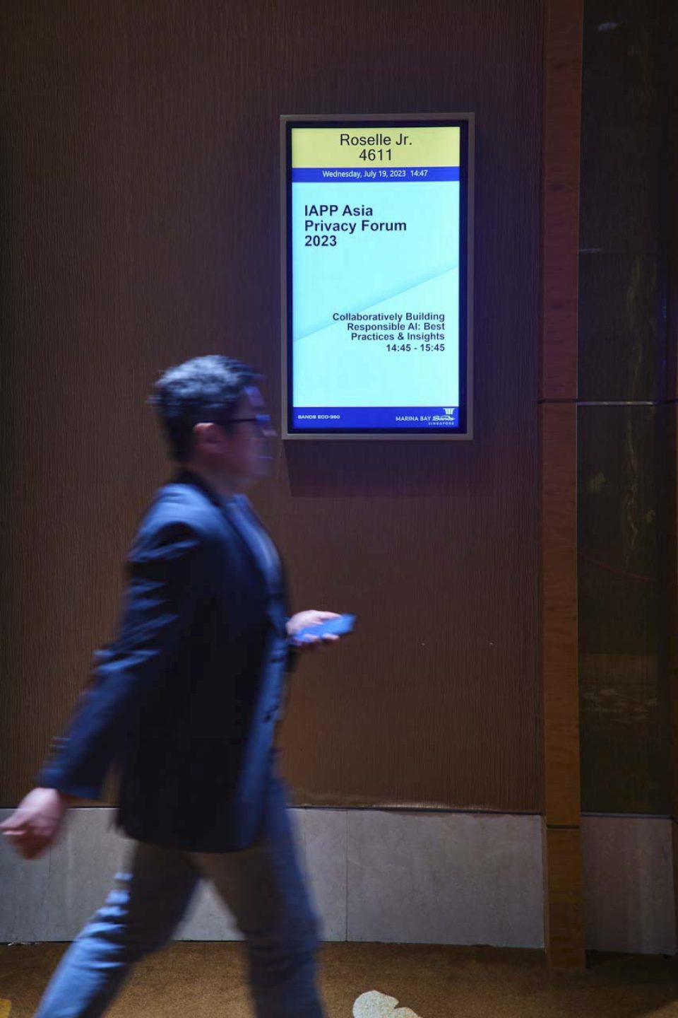 Speaker at the lectern on a darkened stage at the IAPP Asia Privacy Forum 2023 — singapore corporate events photographer, professional corporate events photography singapore