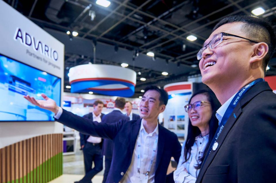 Advario representative presenting to visitors at the company stand during Singapore Maritime Week 2024 — singapore commercial photographer