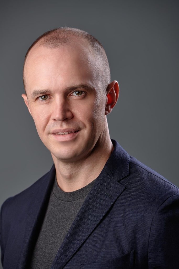 Corporate headshot of Fred Groen, Builder at OpenAI, against a neutral grey studio background