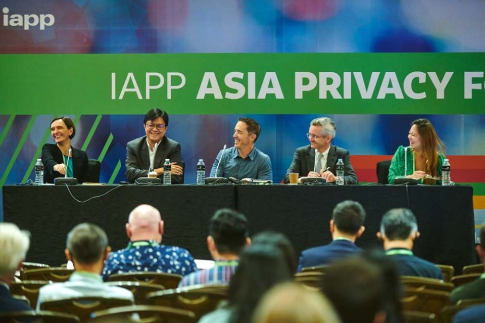 Panel discussion on stage beneath the IAPP Asia Privacy Forum banner — singapore corporate events photographer, professional corporate events photography singapore