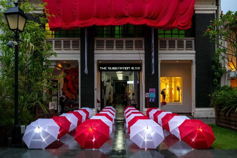 Building entrance dressed with a red and white balloon arch for an official opening ceremony — singapore corporate events photographer, conference photography singapore