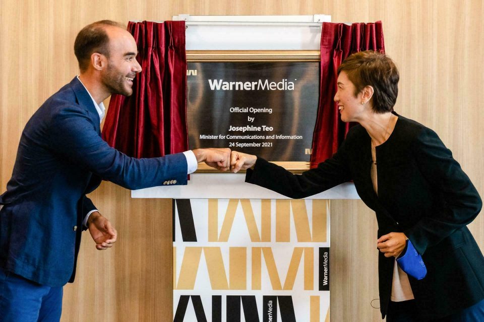 Award presented on a red-curtained stage at a WarnerMedia event in Singapore — singapore corporate events photographer, professional corporate events photography singapore